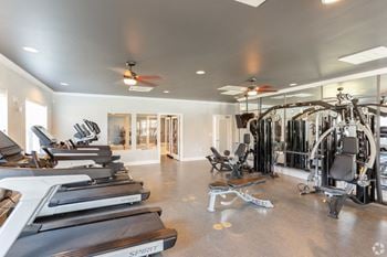 A gym with treadmills and other exercise equipment